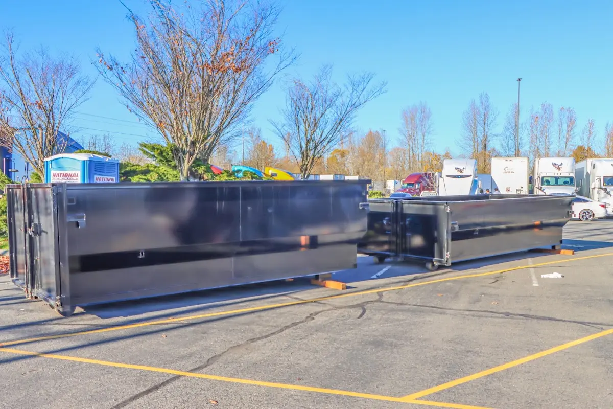 Professional dumpster rental service with roll-off container on residential driveway in Ingleside